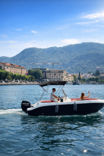 Couple enjoying a self drive boat rental on Lake Como near Como city center
